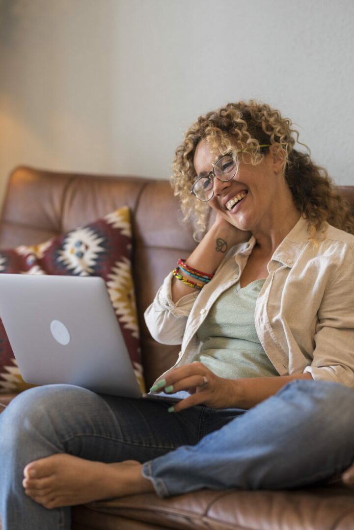 Adult woman sit down on the sofa at home enjoy video call confer